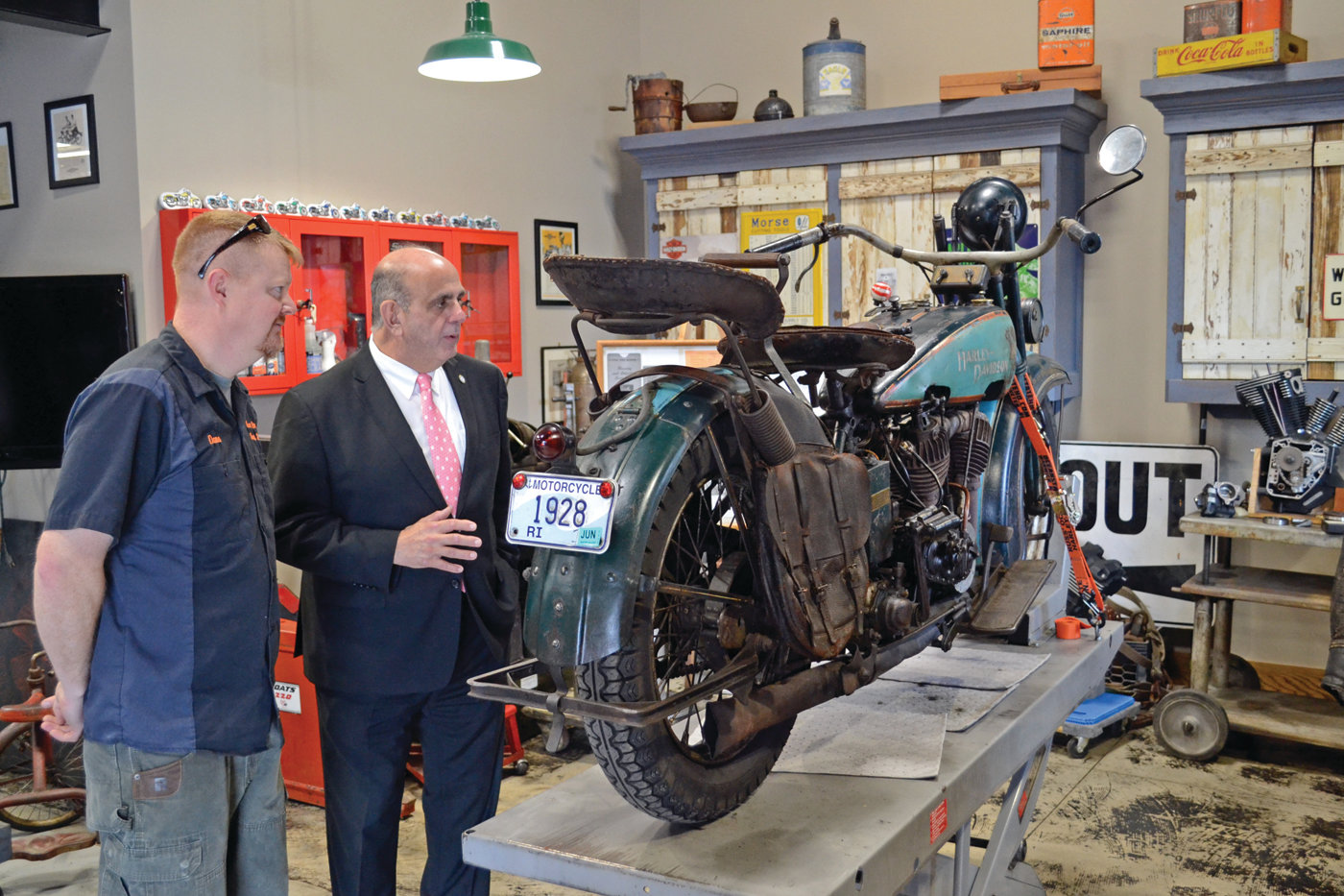 DON’T MAKE EM’ LIKE THIS ANYMORE: Mayor Solomon talks with Dana Bishop, husband to owner Amy Bishop and the director of marketing, about the custom 1928 Harley-Davidson on display in their showroom.
